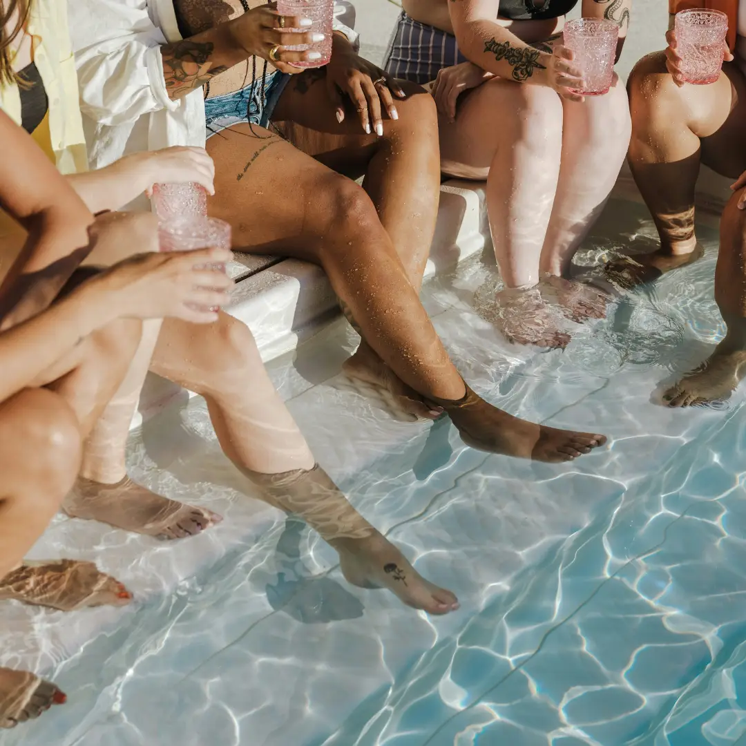 Group of women at the pool with feet in water