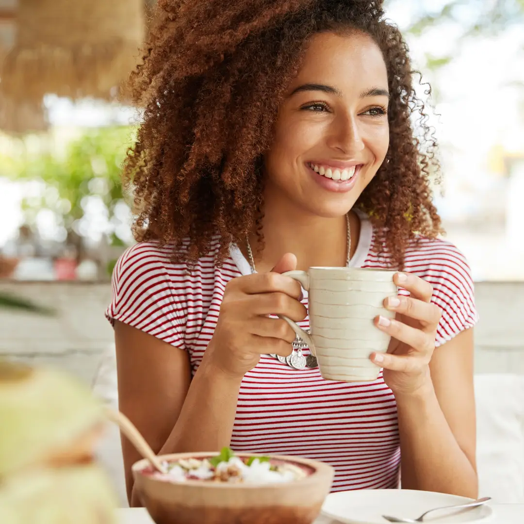 Woman having coffee and breakfast in a cafe