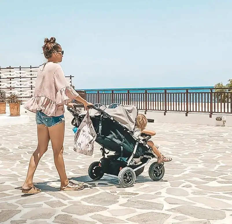 Mum pushing kids in Mountain Buggy Duet