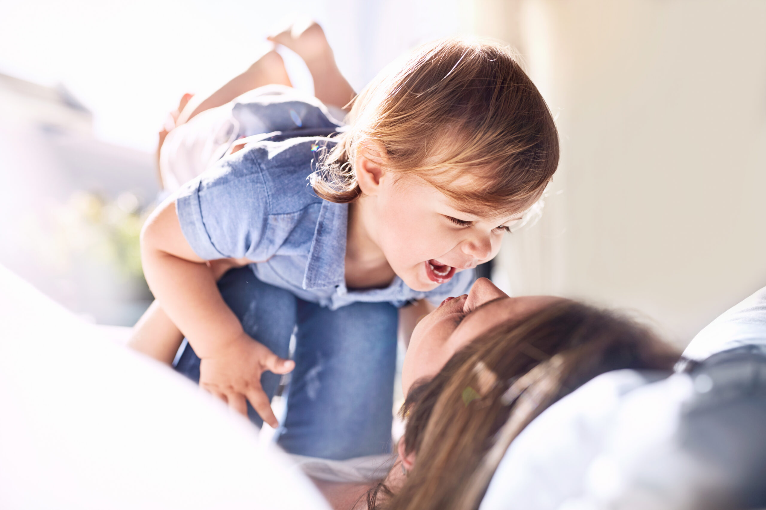 mum and toddler son kaughing and playing